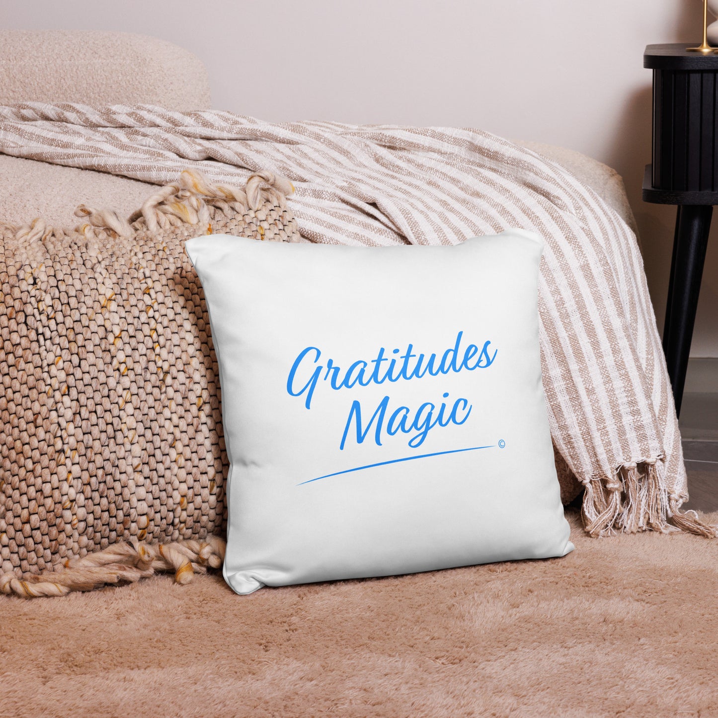 Captivating 18x18 accent pillow spreading the magic of gratitude with 'Gratitude's Magic,' placed gracefully on a pink carpet and a lovely pink checkered scarf.