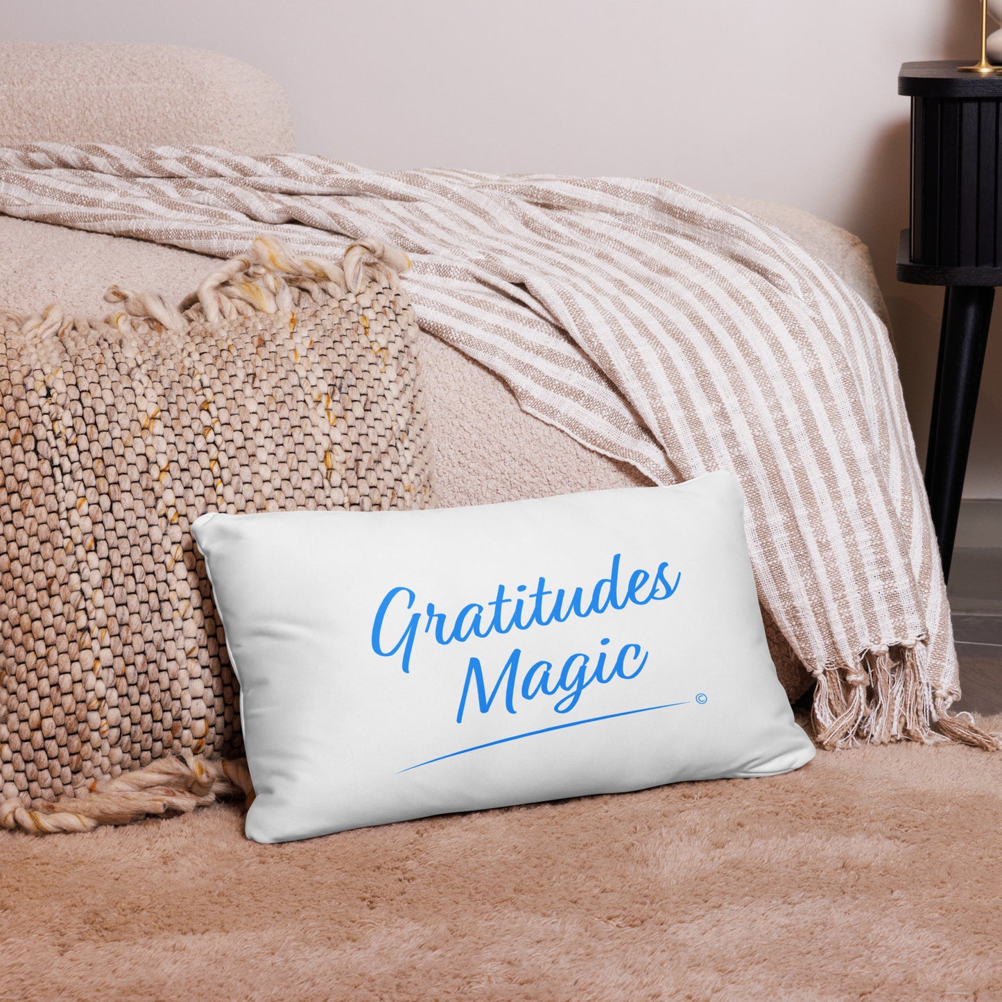 Modern 20x12  pillow adorned with the magical words 'Gratitude's Magic,' creating a whimsical atmosphere on a pink carpet with a matching rug and a stylish pink checkered scarf.