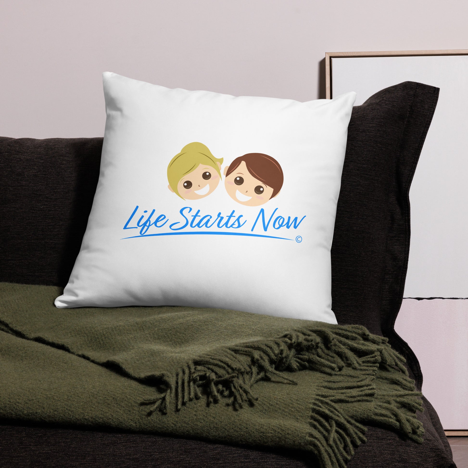 stylish 22x22 throw  pillow on a black bed, displaying the uplifting message 'Life Starts Now. There's a green blanket beside it