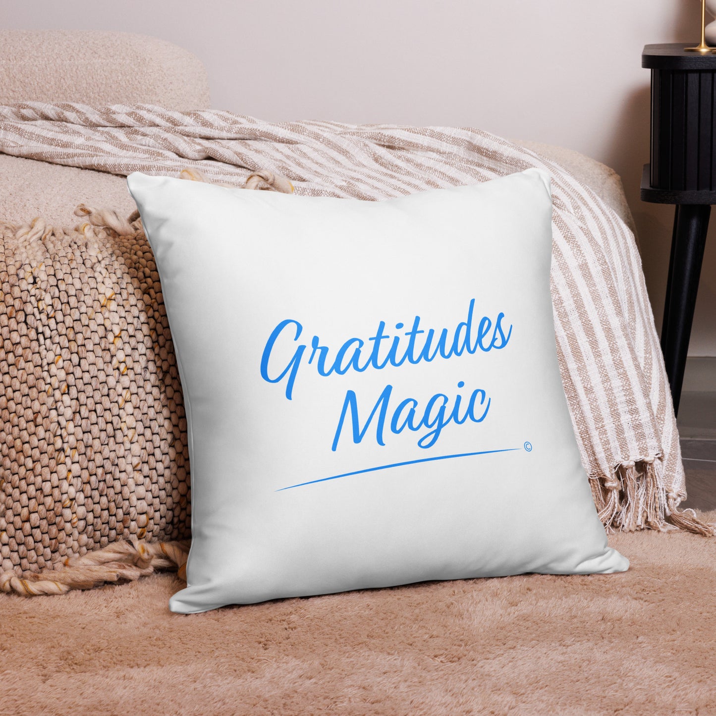 Charming 22x22 throw pillow spreading the enchantment of gratitude with 'Gratitude's Magic,' positioned beautifully on a pink carpet and a fashionable pink checkered scarf.