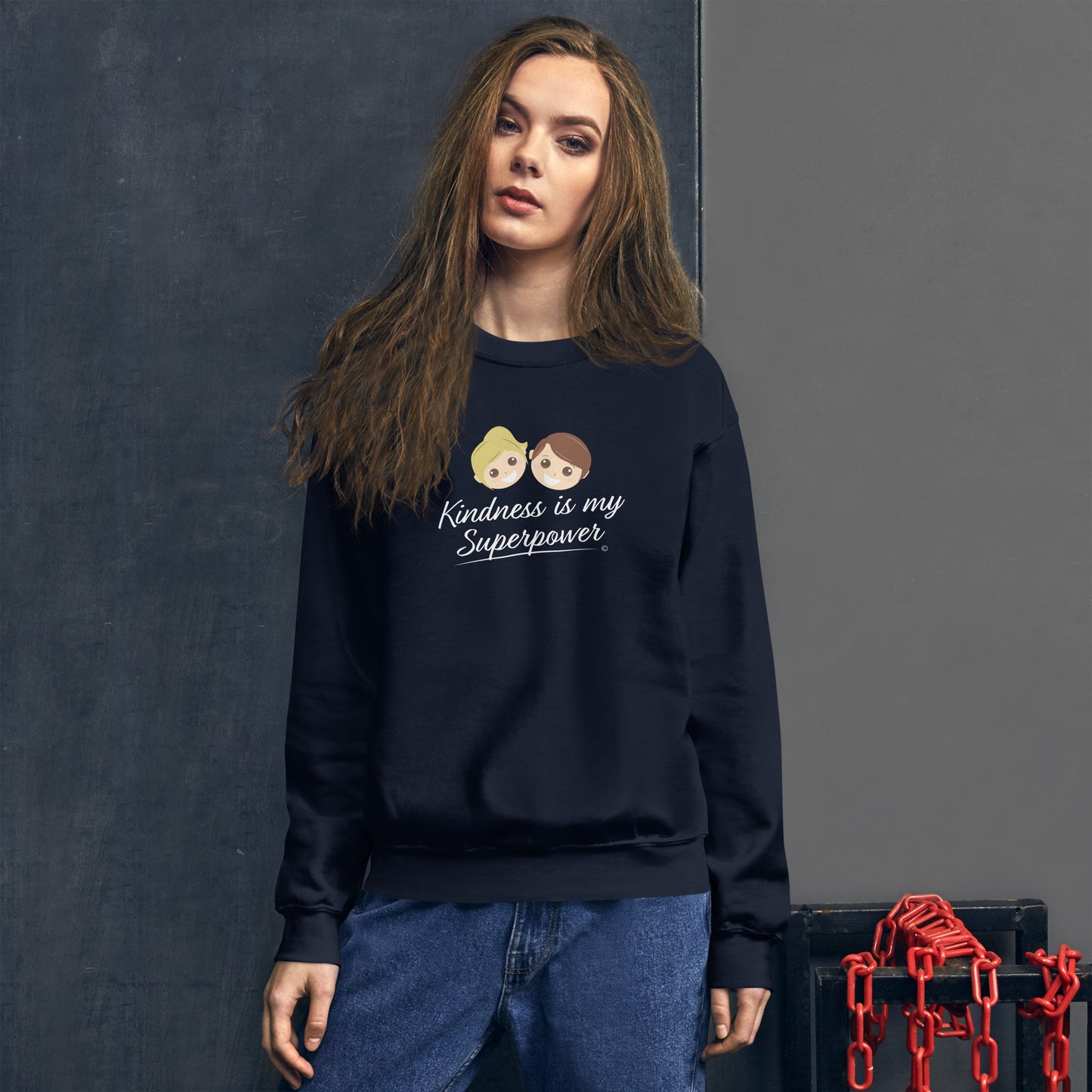 A stylish  woman confidently modeling a cozy unisex sweatshirt in navy, both adorned with the empowering quote 'Kindness is my Superpower' in bold lettering.