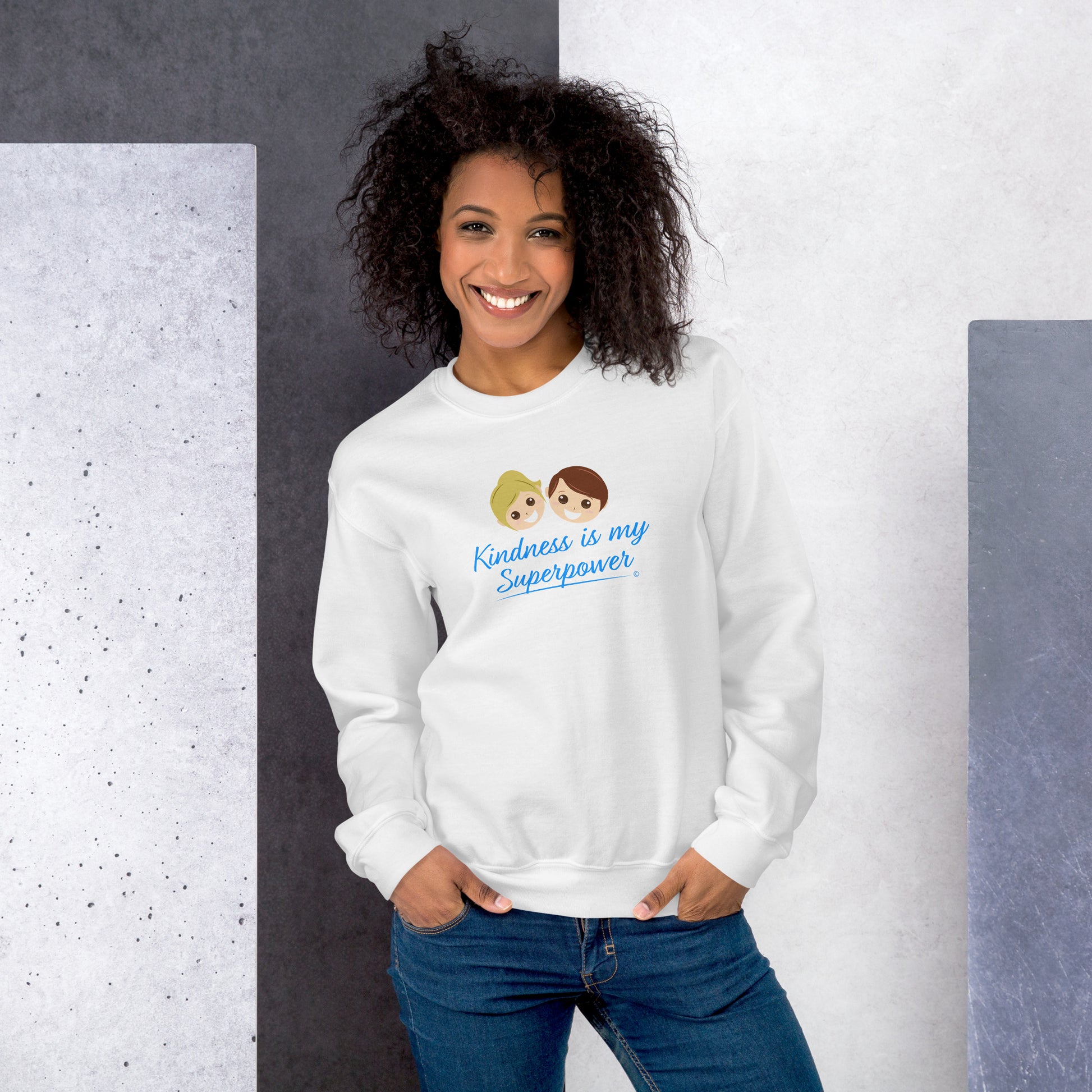 A stylish woman confidently modeling a cozy unisex sweatshirt in white,  adorned with the empowering quote 'Kindness is my Superpower' in bold lettering.