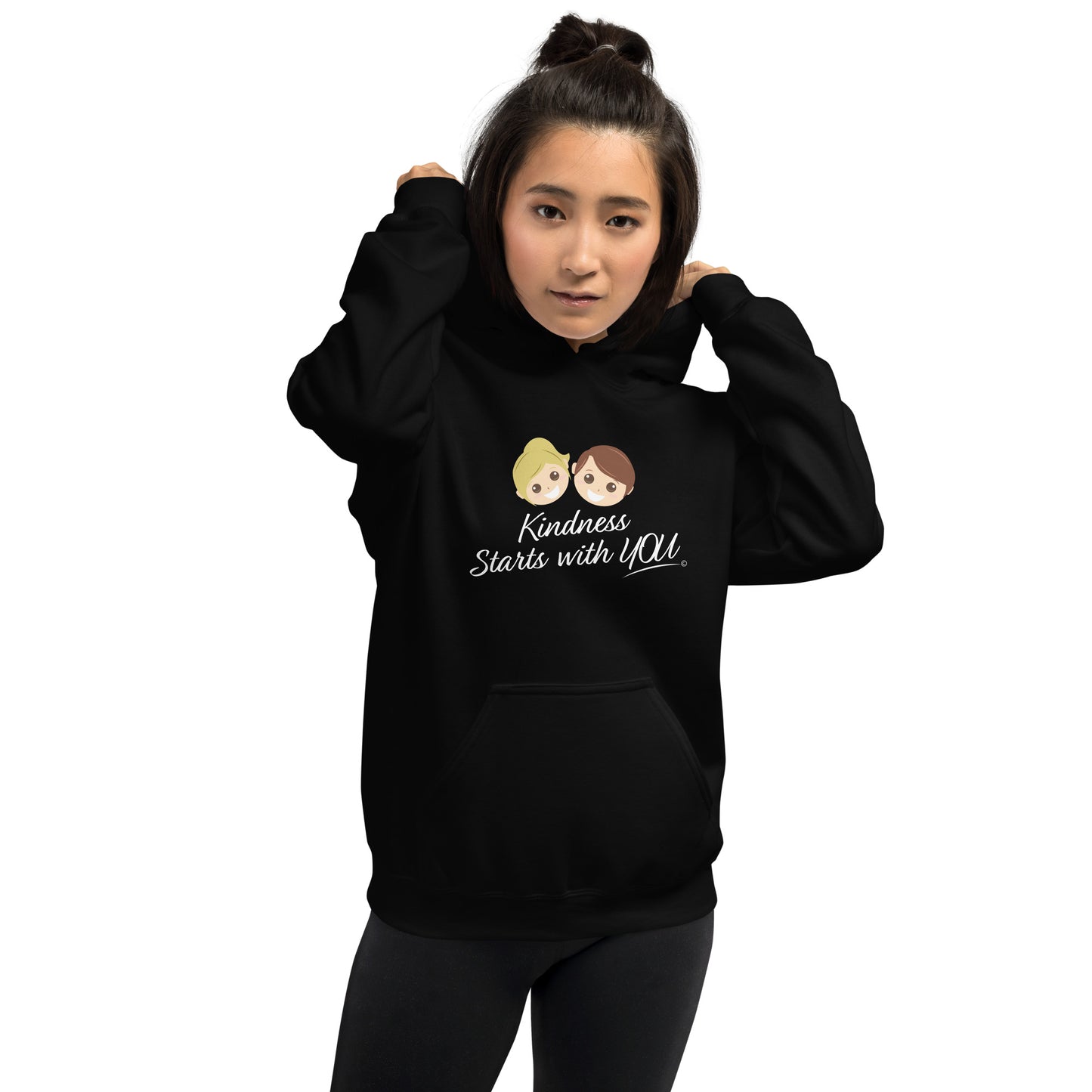 A confident woman young modeling a cozy unisex hoodie in black, featuring the uplifting quote 'Kindness Starts with You' in bold lettering.