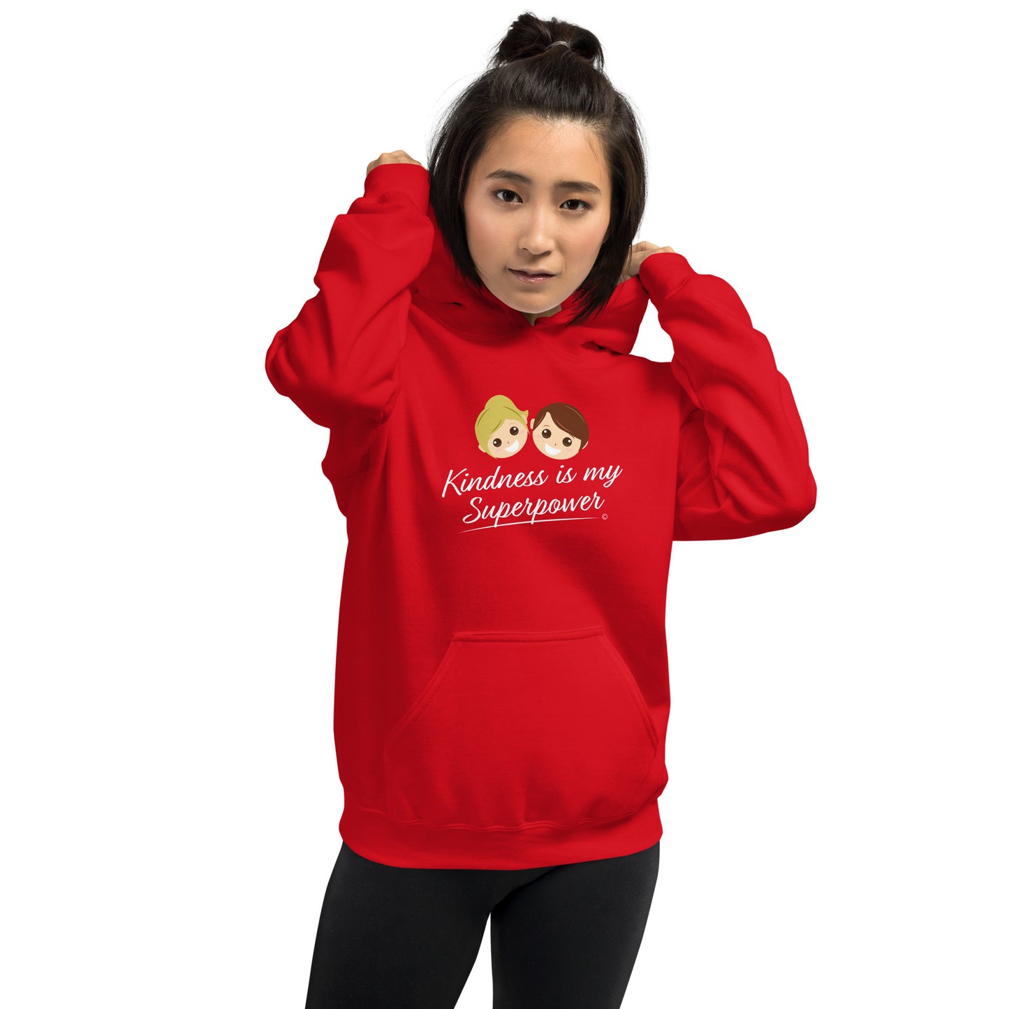 A confident woman showcasing a comfortable unisex hoodie in red, featuring the uplifting quote 'Kindness is my Superpower' in bold lettering.