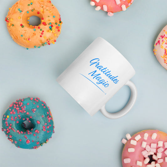 Elegant white ceramic coffee mugs with donuts in the background