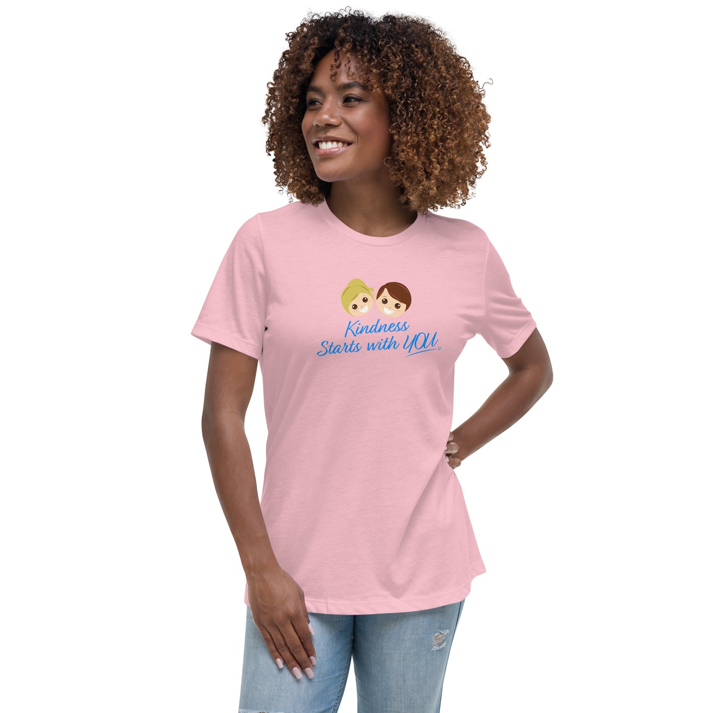 A confident woman showcasing a stylish women's shirt in pink, featuring the empowering quote 'Kindness Starts with You' in bold lettering.